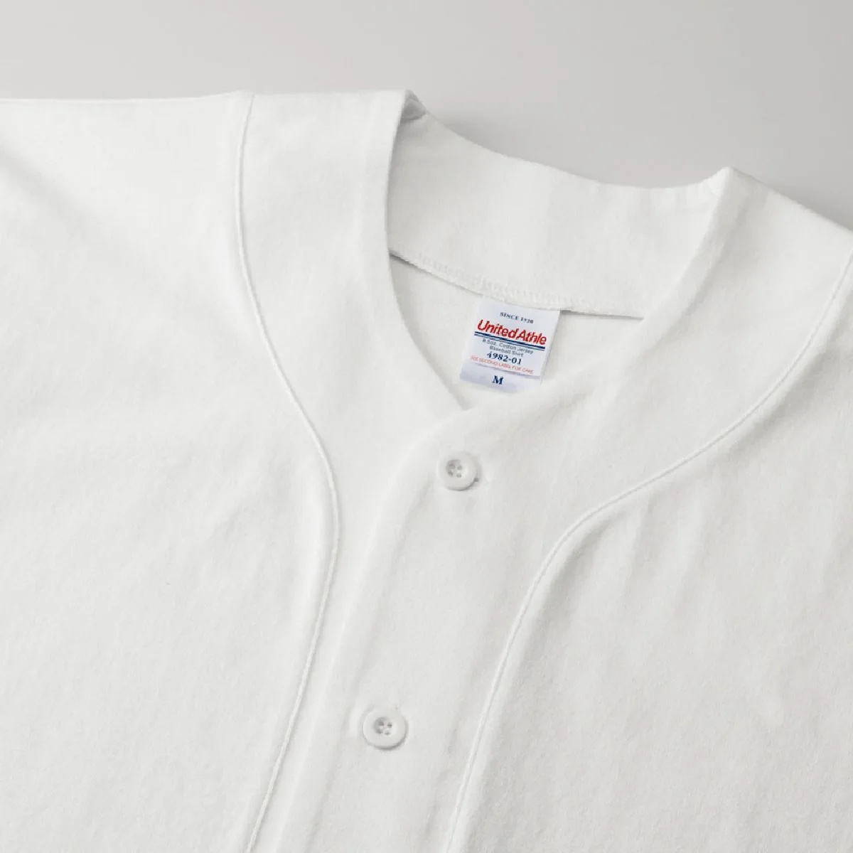 4982-01 8.5oz Cotton Jersey Baseball Shirt 6 To counter lateral forces, the first buttonhole is the horizontal hole.