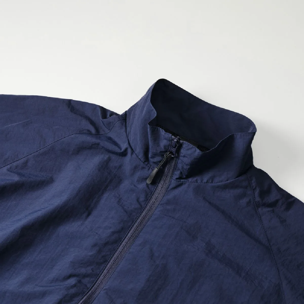 The collar is a stand color reminiscent of military training wear