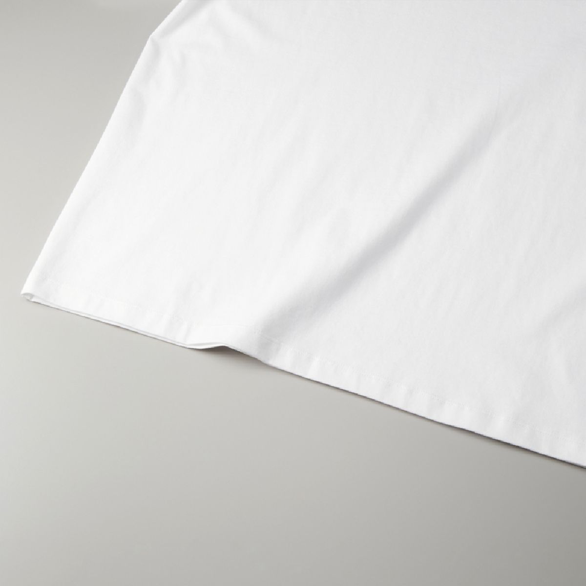 The hem is finished with a narrow double-needle stitch.