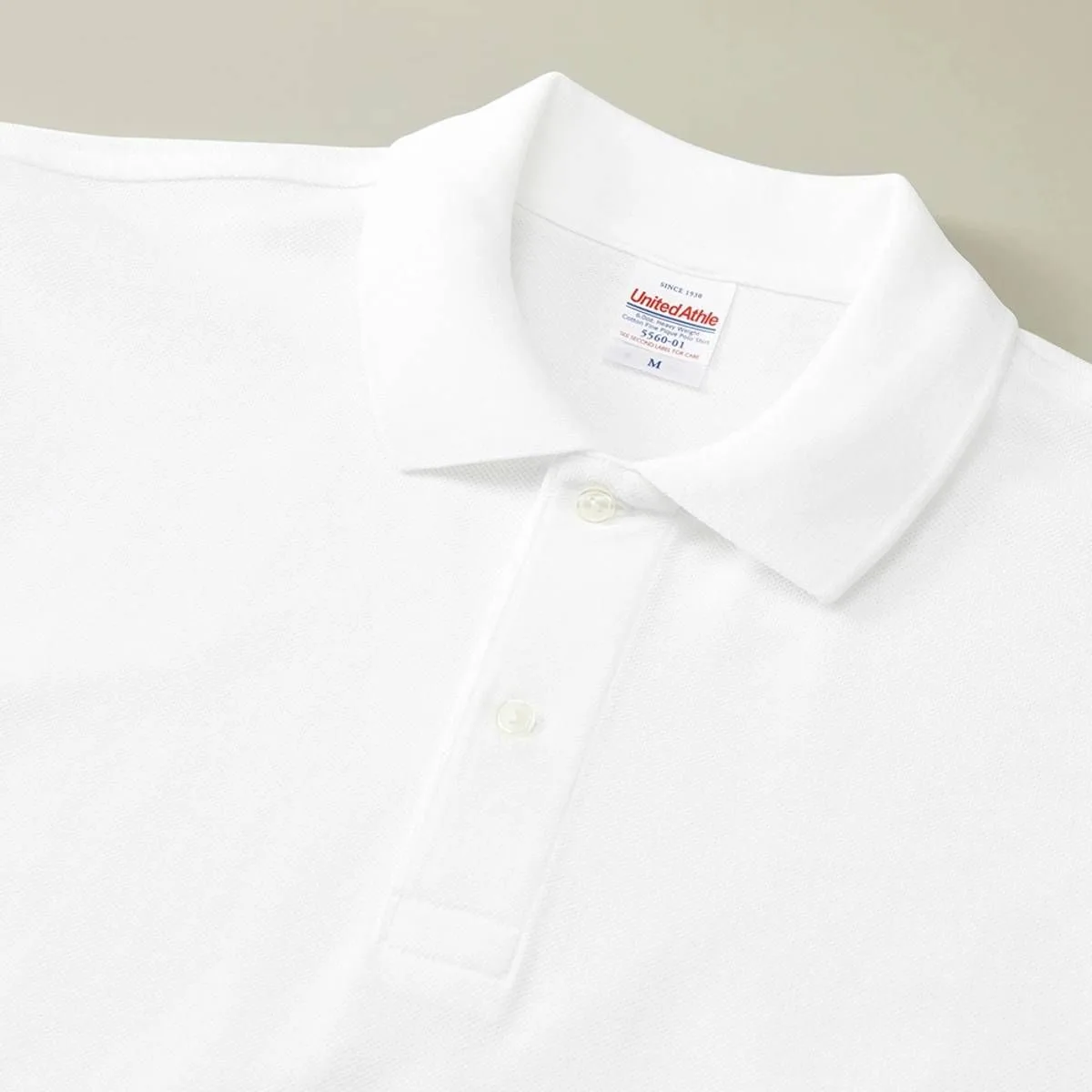 The collar is ribbed, and the 001. White and 011. Dark Gray versions use milky white two-hole buttons.