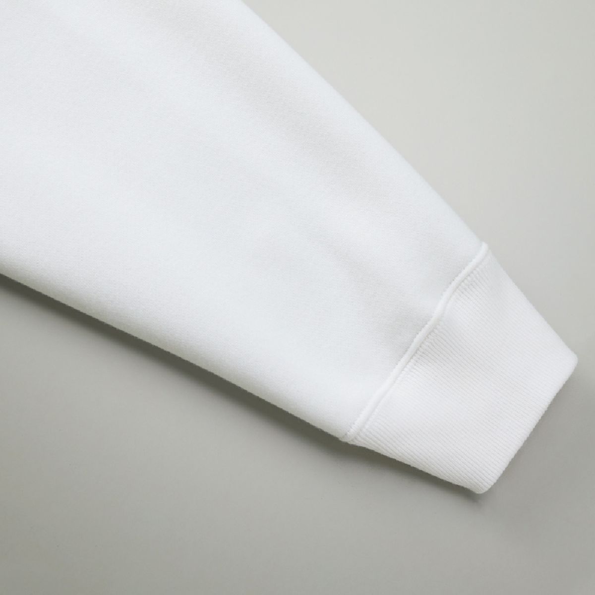 The cuffs are ribbed, and the seams are finished with a robust double-needle stitching.