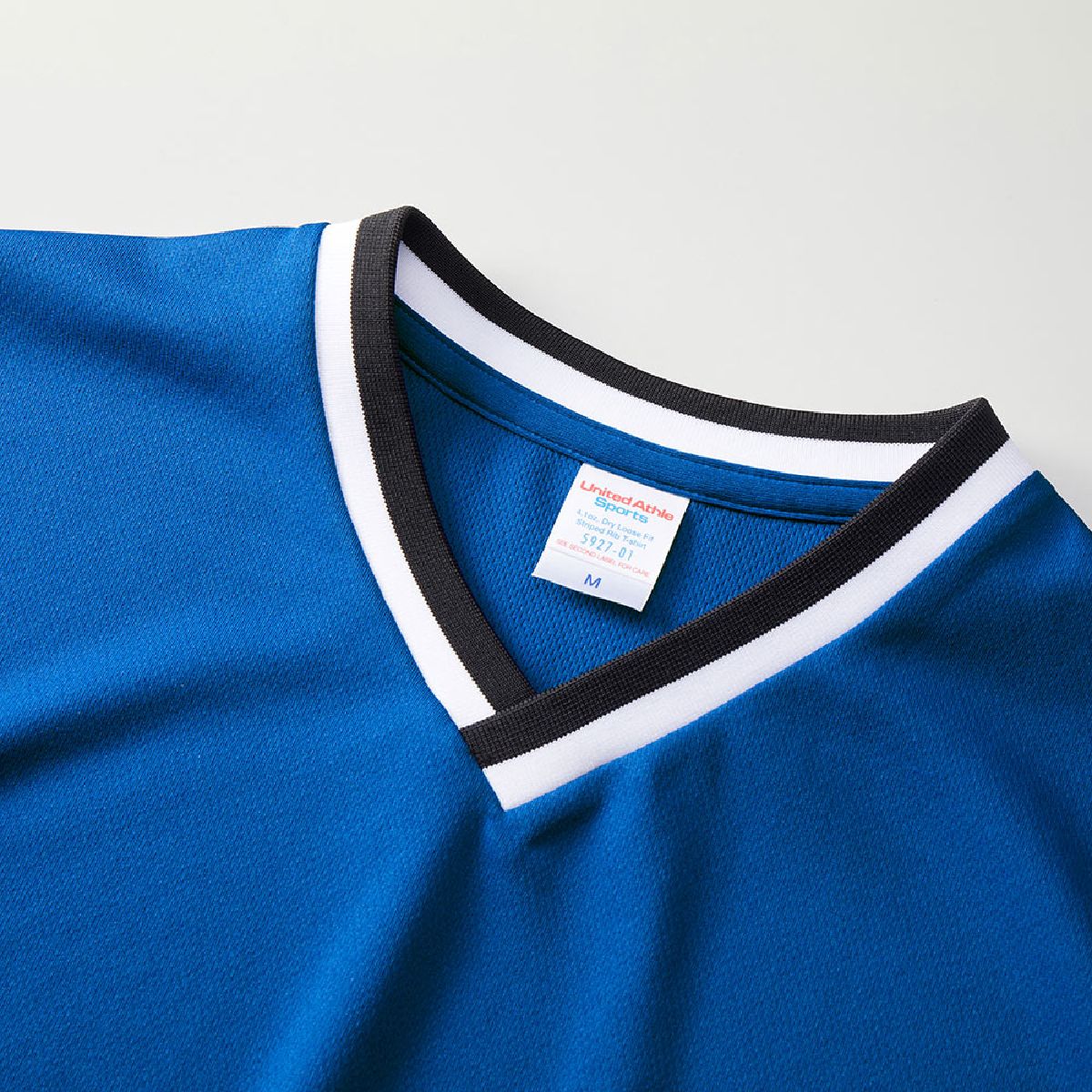The neckline features a two-tone V-neck design.