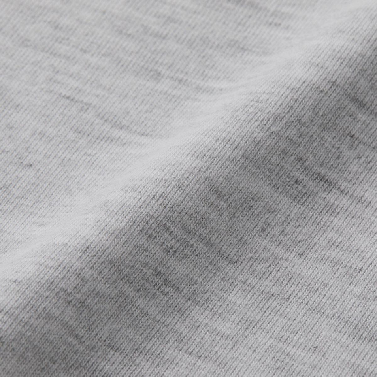 This jersey fabric is a blend of three types of yarn: cotton, polyester, and rayon, and features a soft feel against the skin and a distinctive coarse heathered texture.