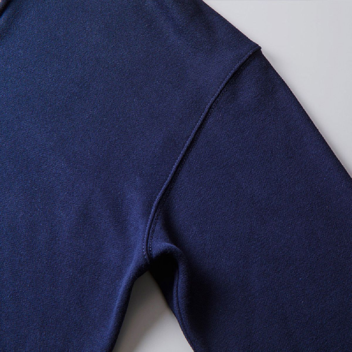 The armhole seam line is finished with a sturdy double stitch using a coarse stitch count.