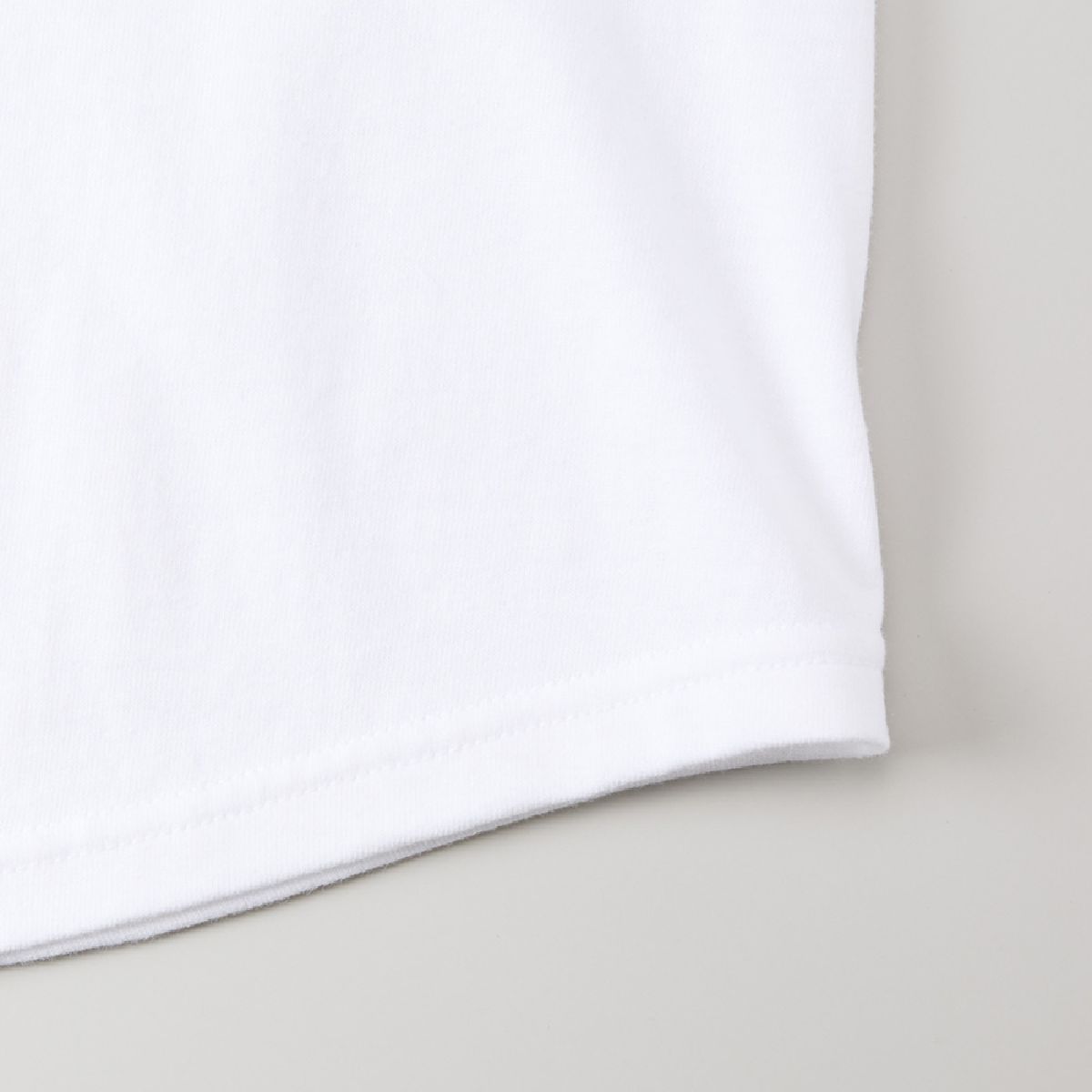 The hem has a rounded tail and is finished with a flat stitch.