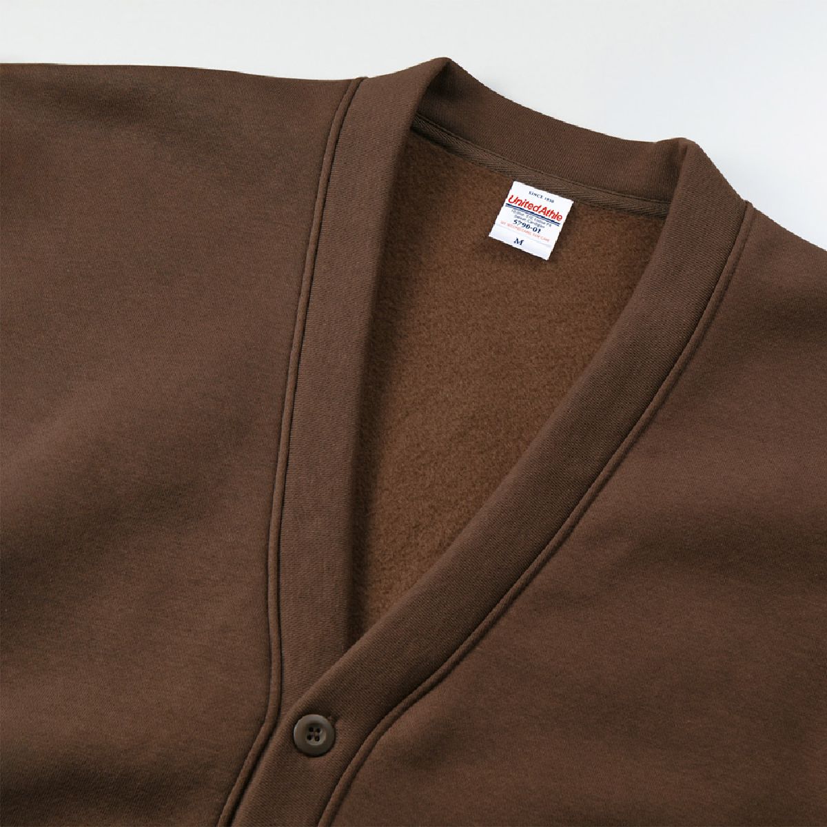 The placket is made of the same sweat fabric as the body of the garment.