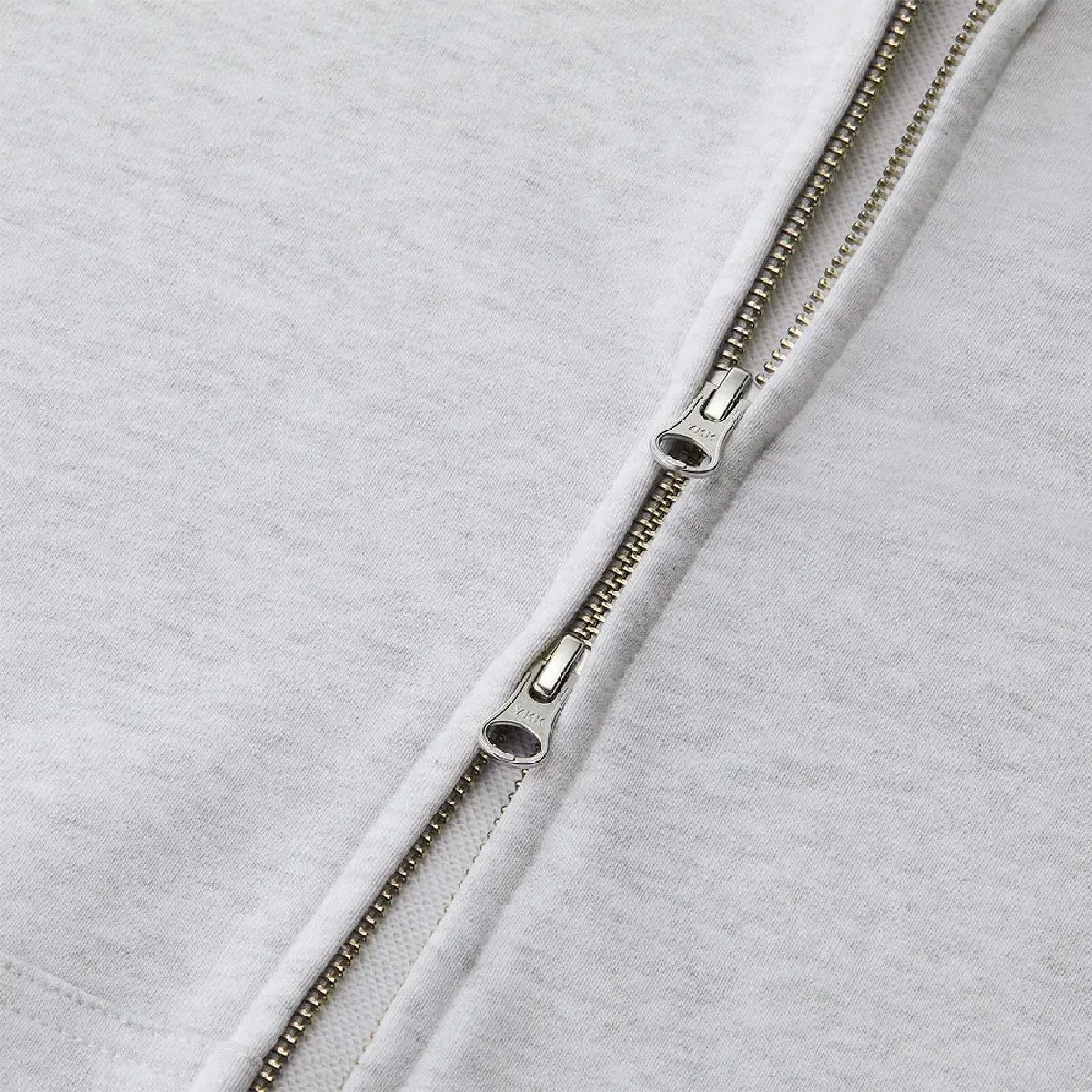 The zipper is concealed, made by YKK, with a double slider and a DALH-type pull tab.