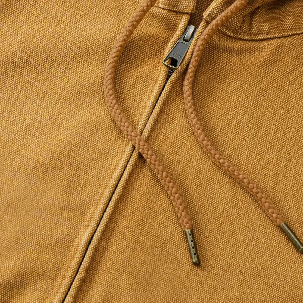 The hood drawstring is a round cord in the same color as the body, with metal tips at the ends.
