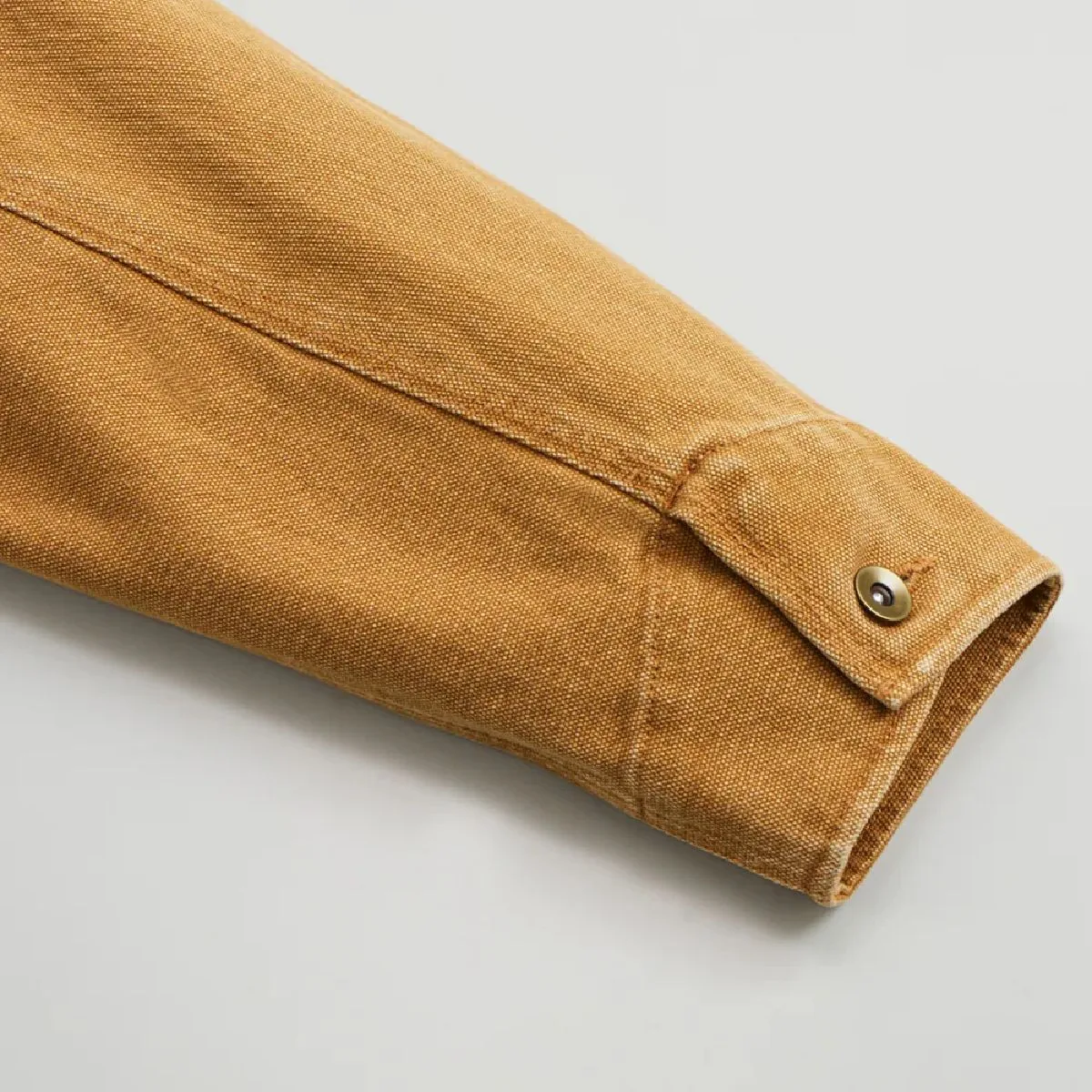 The cuffs have tack buttons.