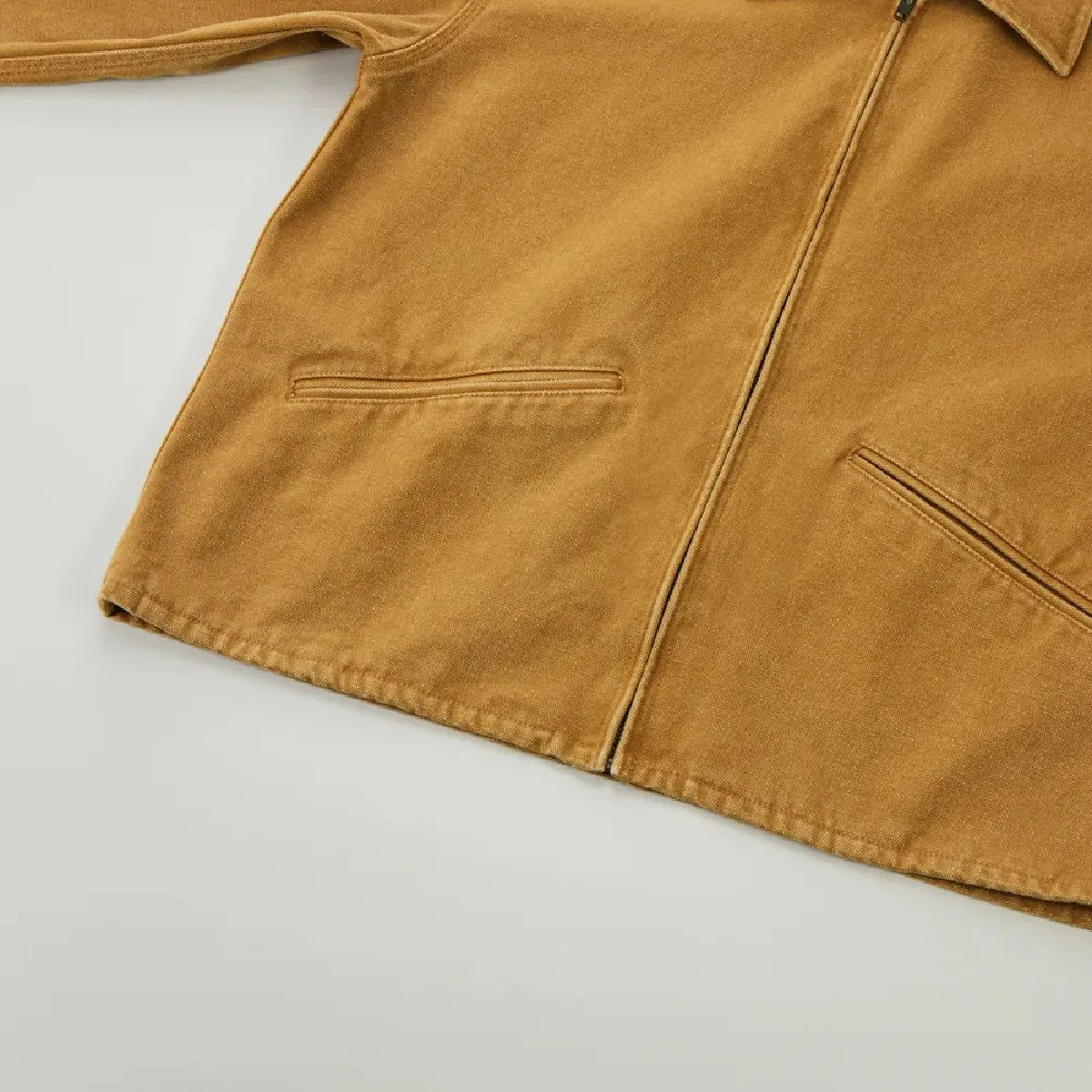 The hem is finished with a single stitch, and the resulting wear along the seam line creates a vintage feel.